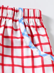 Baby shorts with red and white gingham pattern and blue trim detail