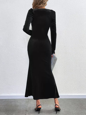 Black velvet mermaid dress with square neckline and long puff sleeves.