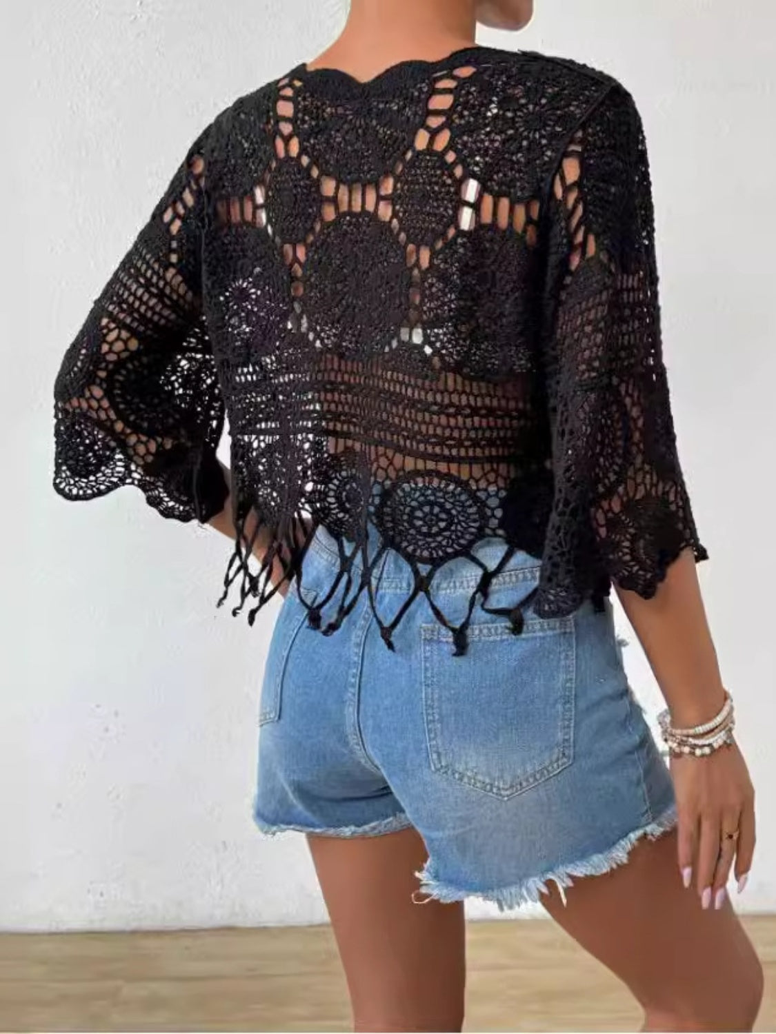 Black crochet medallion fringe top with bell sleeves and a scalloped hem.
