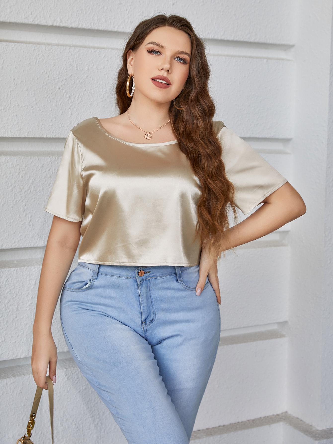 Gold satin blouse with short sleeves and a scoop neck.