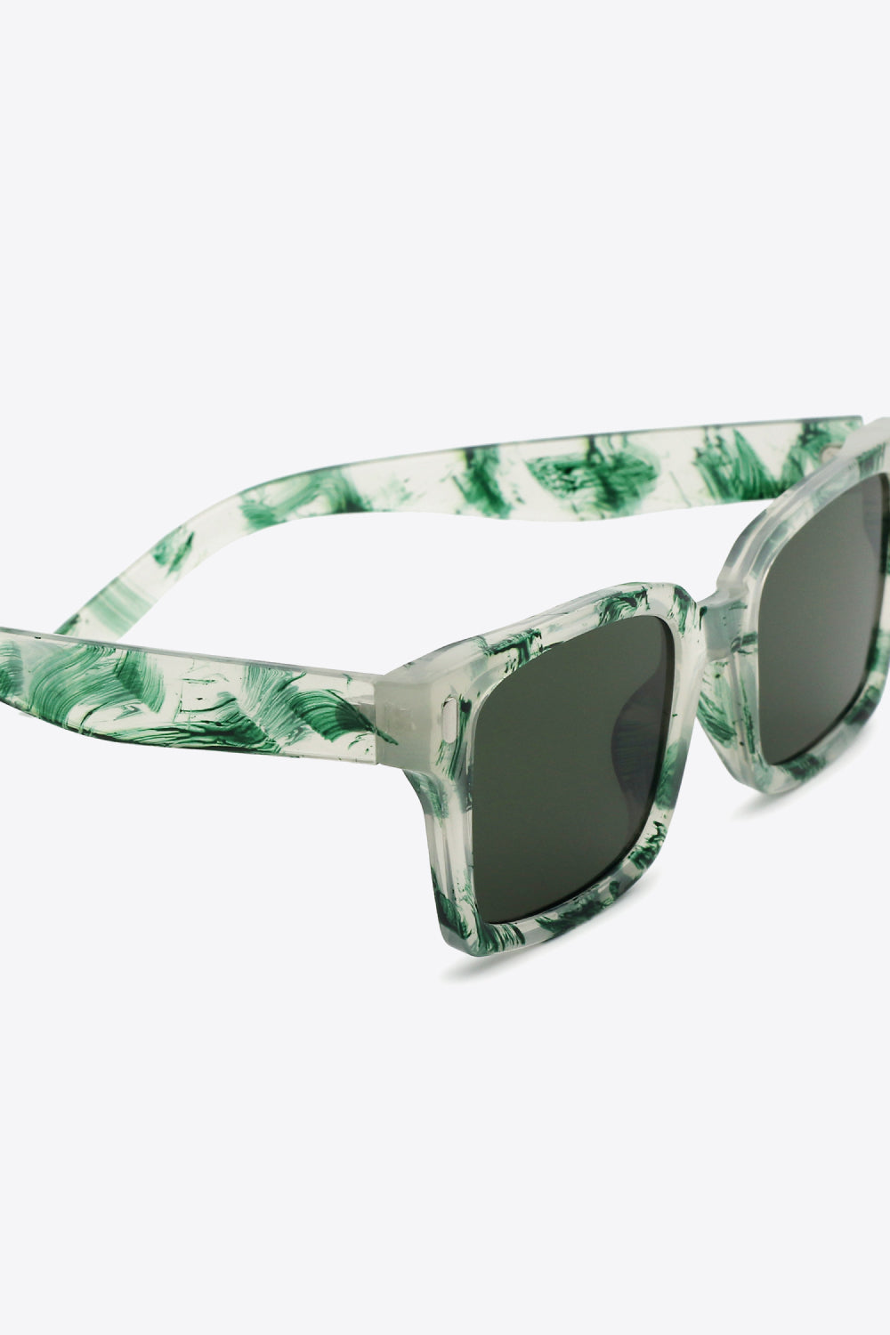 Forest marble effect rectangular sunglasses with dark lenses and clear frames.