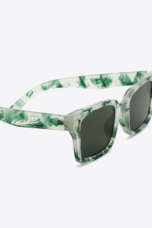 Forest marble effect rectangular sunglasses with dark lenses and clear frames.