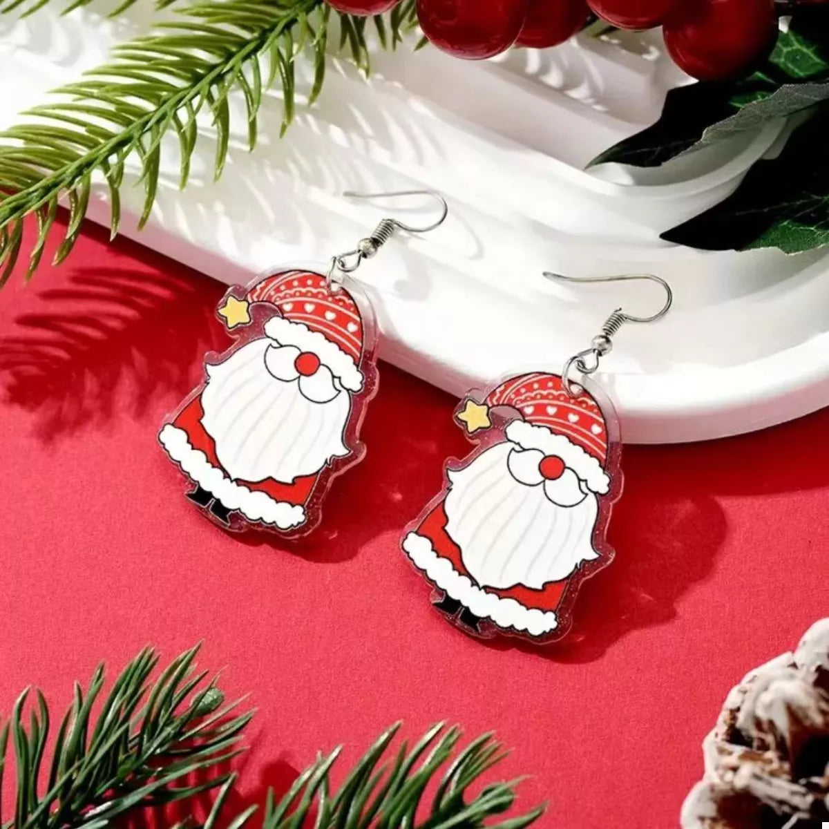 Red Santa Claus acrylic dangle earrings with star detail.