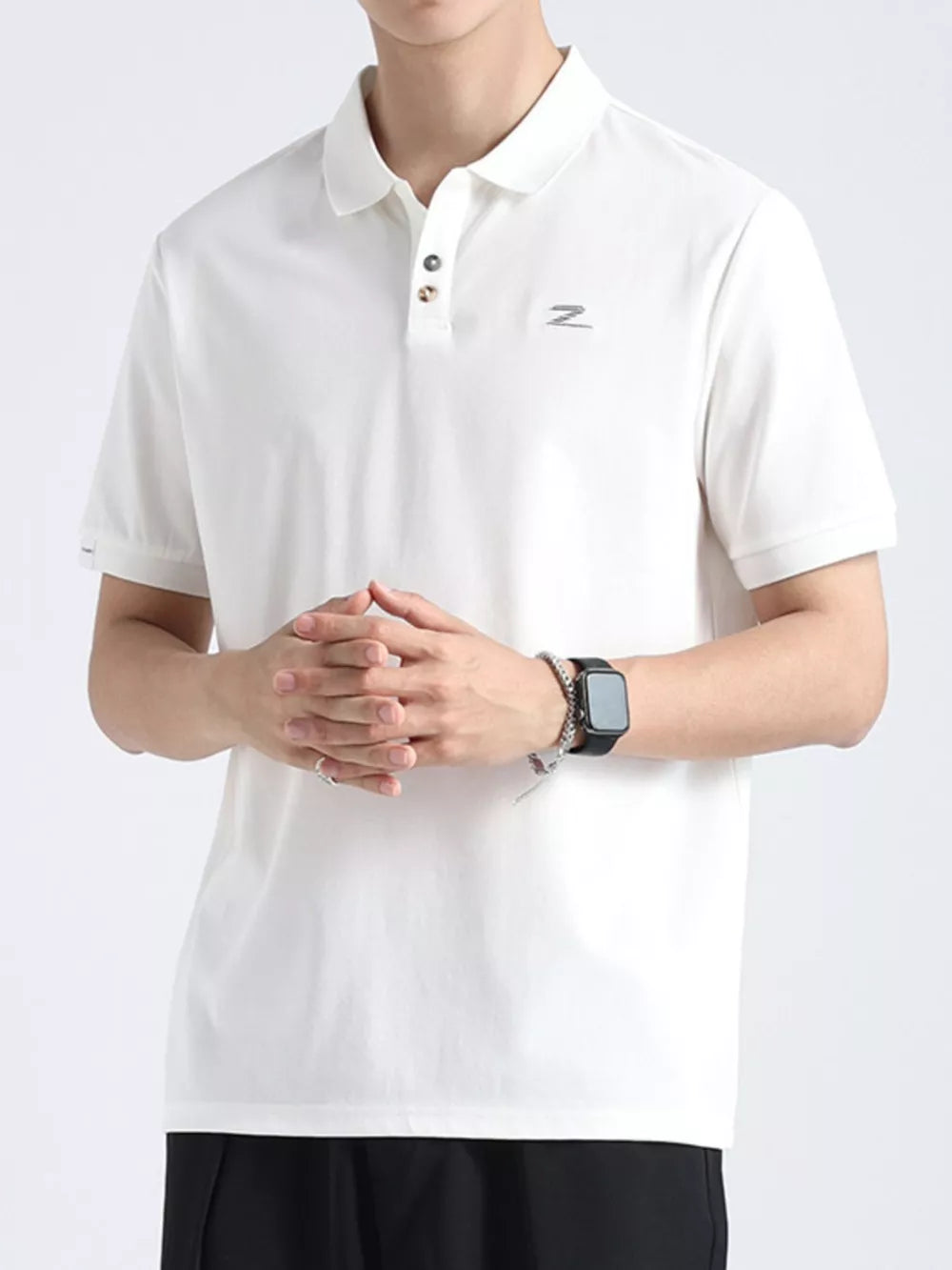 White textured cotton polo shirt with button accents and a subtle logo detail.