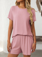 Blush pink ribbed loungewear set with raw edge details on the t-shirt and shorts.