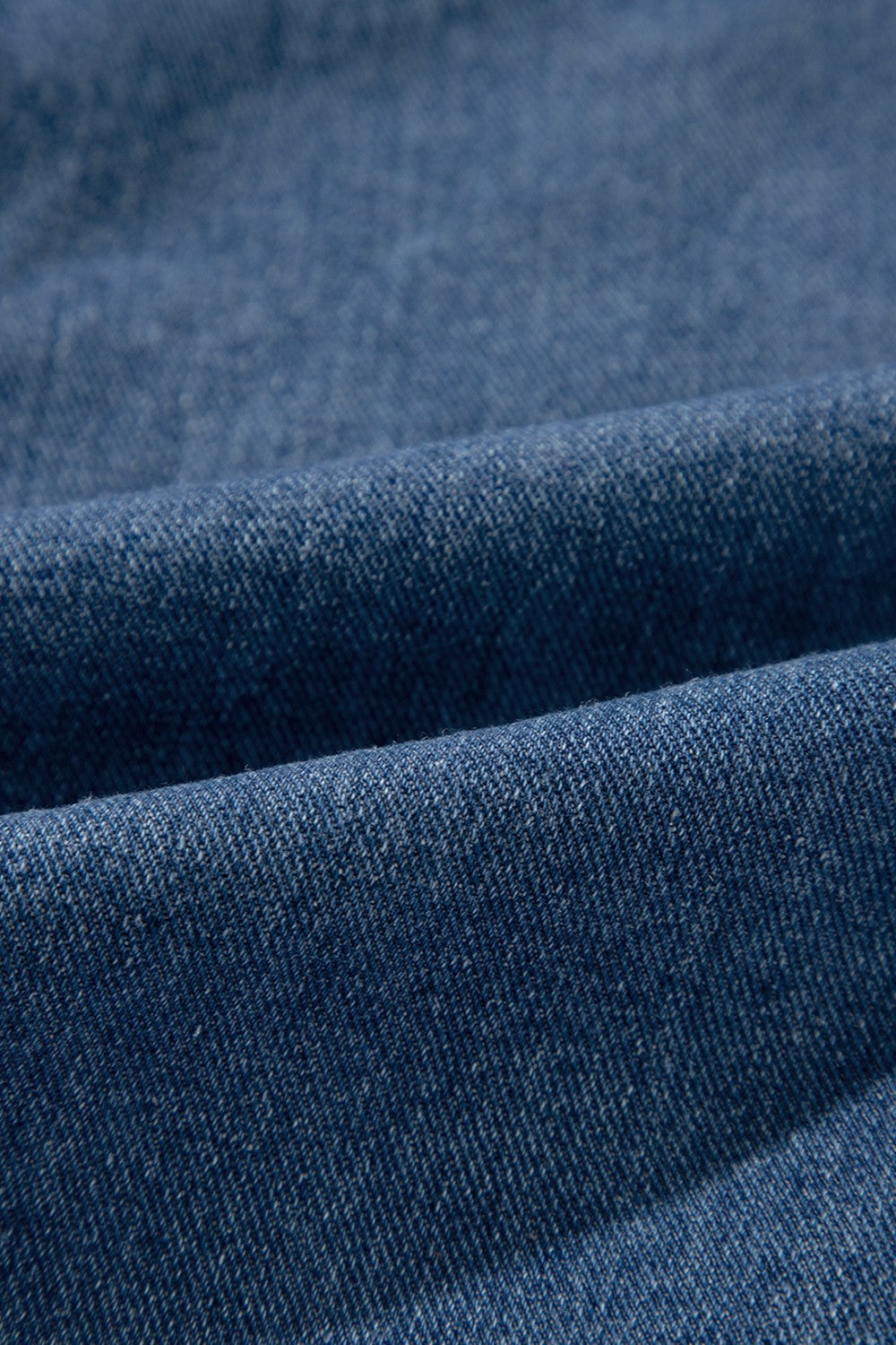 Medium wash denim blazer fabric detail
