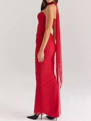 Red sweetheart tube top and flowy maxi skirt set with sheer cape detail.