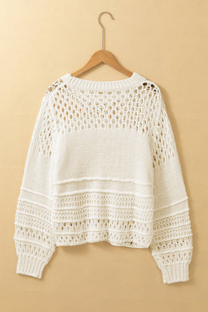 Ivory openwork knit pullover sweater with balloon sleeves and textured details.