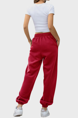 Slouchy sweatpants in Deep Red with gathered cuffs and pockets.