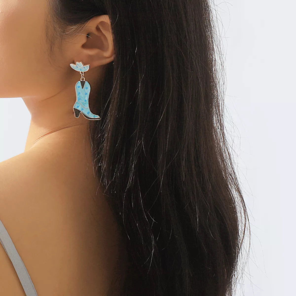 Blue cowboy boot dangle earrings with white polka dots and a matching hat detail.