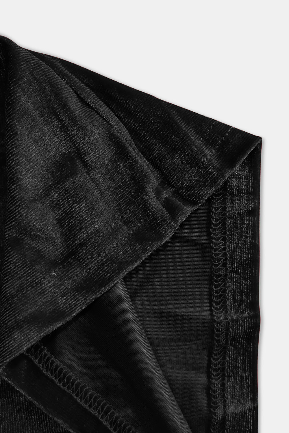 Plush velvet wide-leg trousers in black, showing seam detail and fabric texture.