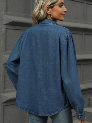 Navy denim shirt with puffed sleeves and buttoned cuffs.