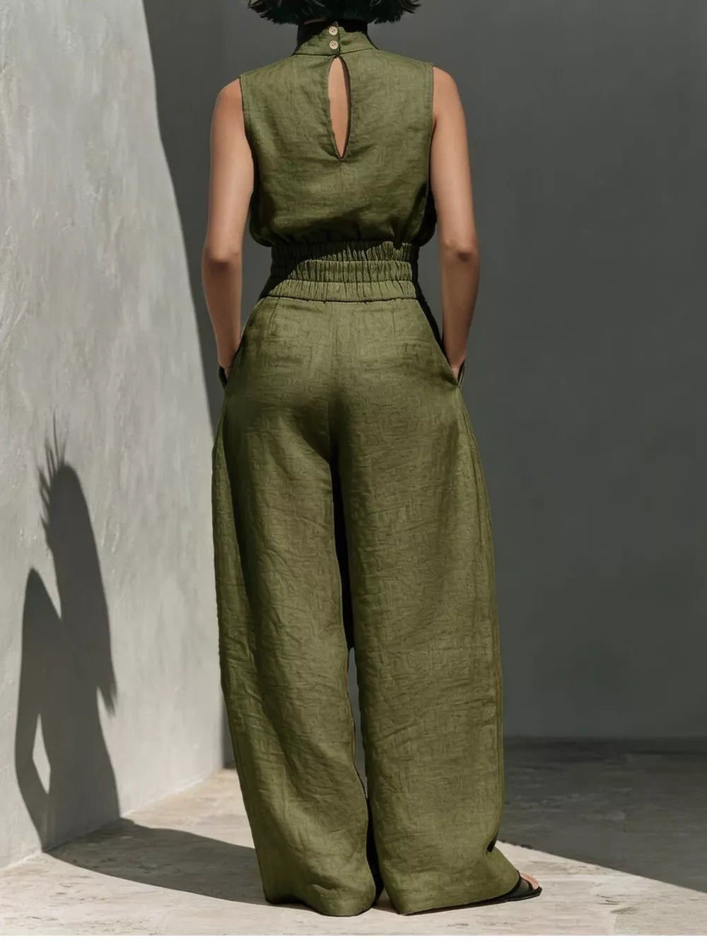 Army green sleeveless turtleneck top with keyhole back and wide-leg pants set.