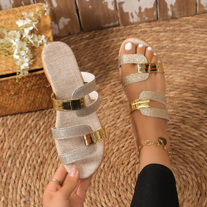 Glistening dual-strap wedge sandals in gold and silver glitter with a textured sole.