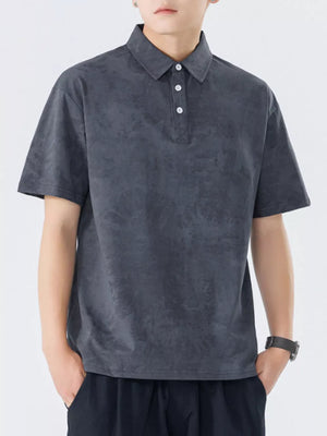 Dark gray cotton polo shirt with subtle texture and buttoned placket.