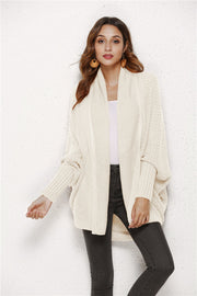 Ivory cocoon knit cardigan with shawl collar and batwing sleeves.