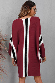 Burgundy knit cocoon dress with white and black stripe details on sleeves and back.