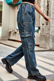 Cargo denim relaxed fit trousers in dark wash with multiple pockets and elastic waistband.