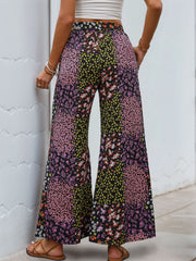 Floral panel palazzo trousers in black with a vibrant floral print and wide leg.