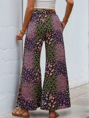 Floral panel palazzo trousers in black with a vibrant floral print and wide leg.