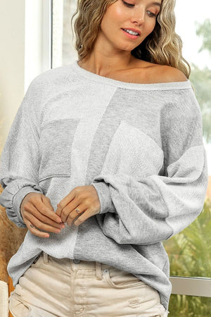 Colorblock sweatshirt in light gray with two front pockets and slouchy sleeves.