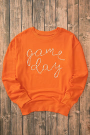Orange crewneck sweatshirt with white beaded Game Day graphic