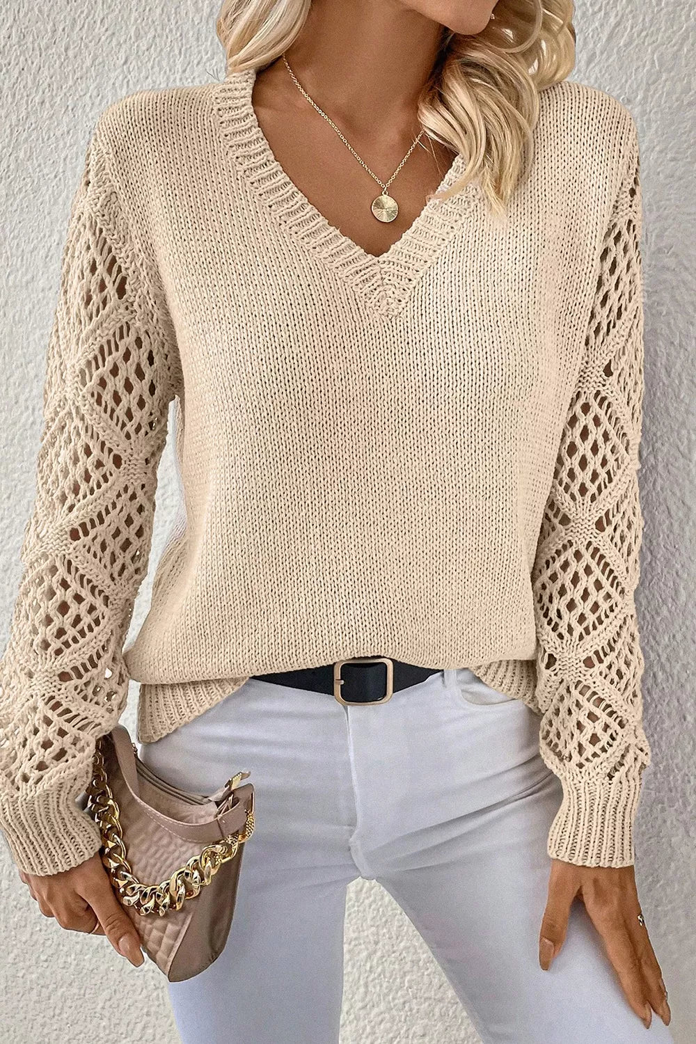 Beige knit sweater with crochet diamond sleeves and V-neck.