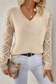 Beige knit sweater with crochet diamond sleeves and V-neck.
