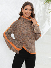 Colorblock raglan sleeve turtleneck sweater in acrylic with orange stripe details.