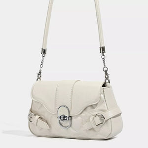 White heart-quilted crossbody bag with buckle accents and silver chain strap detail.