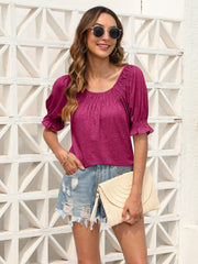 Off-shoulder ruffled sleeve blouse in hot pink with smocked neckline and cuffs.
