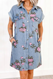 Denim shirt dress with pink floral print, short sleeves, and button front.
