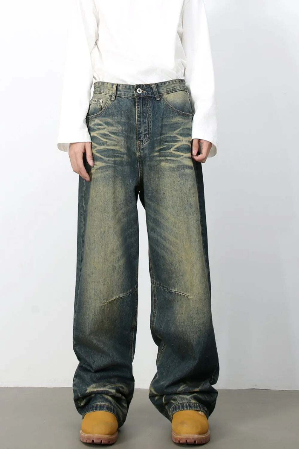 Distressed denim wide-leg trousers in medium wash with a relaxed fit and vintage fade.