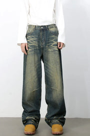 Distressed denim wide-leg trousers in medium wash with a relaxed fit and vintage fade.