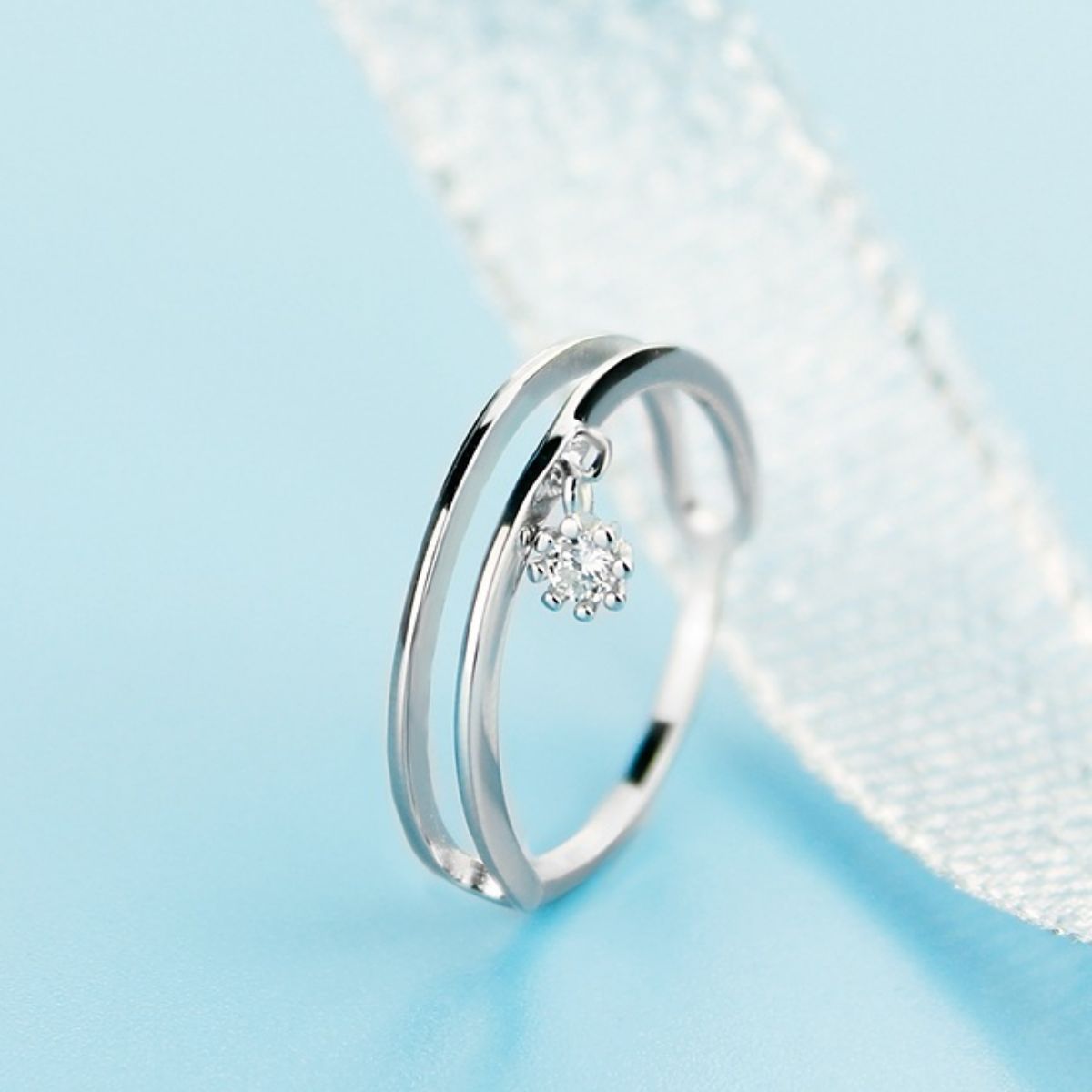 Sterling silver double layered ring with a dangling crystal charm.