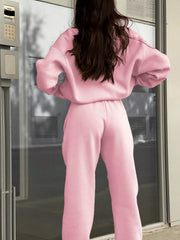 Blush pink athleisure sweatshirt and pants set with a half zip and comfortable fit.