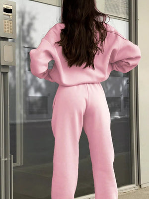 Blush pink athleisure sweatshirt and pants set with a half zip and comfortable fit.