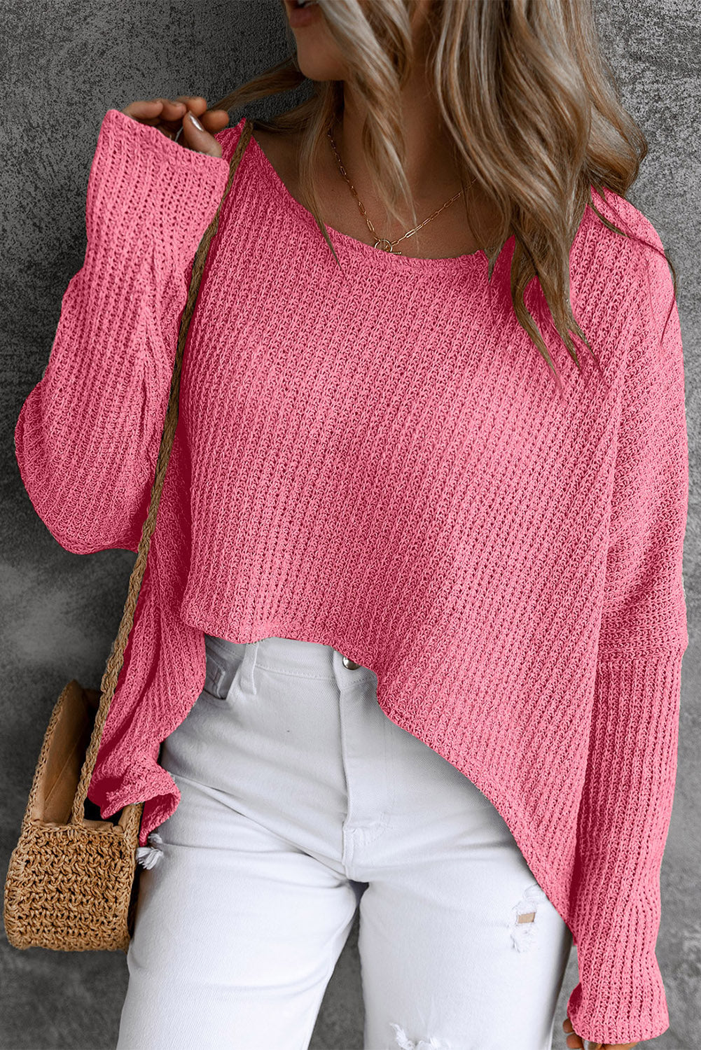 Asymmetric slouch knit top in strawberry acrylic with a relaxed fit and uneven hem.