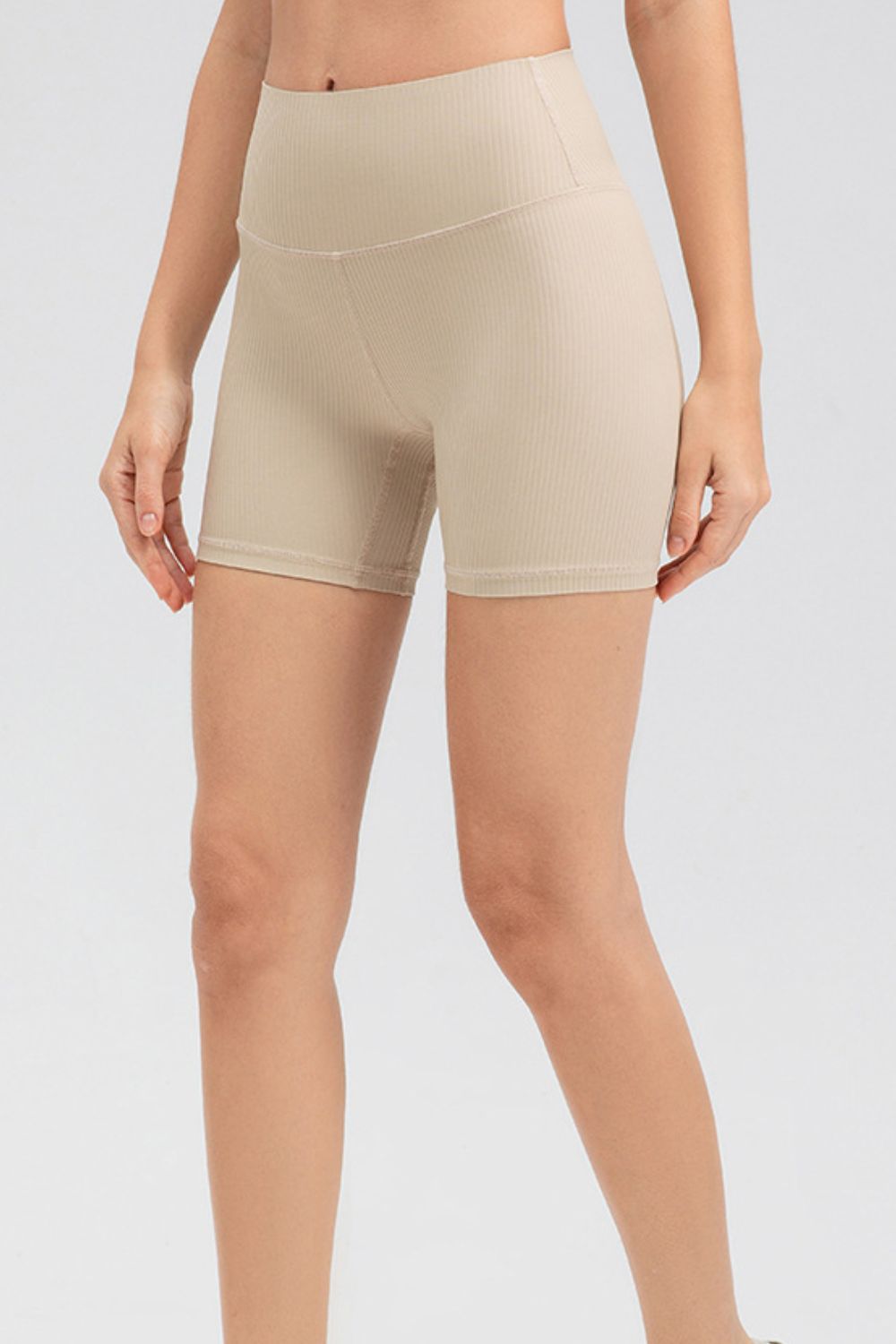 Tan ribbed contour active bike shorts with a high waist.