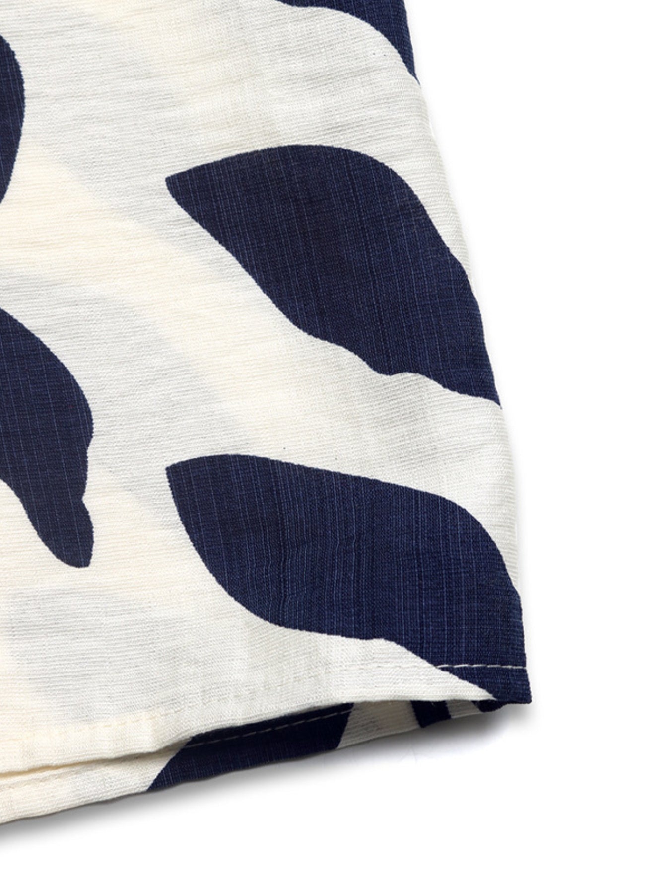 Chic smocked tube romper in white with navy abstract print and button detail.