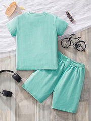 Toddler two-piece set in mint green cotton, featuring a short-sleeve tee and elastic waist shorts.