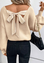 Beige ribbed knit sweater with a satin bow back detail and balloon sleeves.
