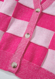 Hot pink checkerboard knit cardigan with button front and ribbed trim.