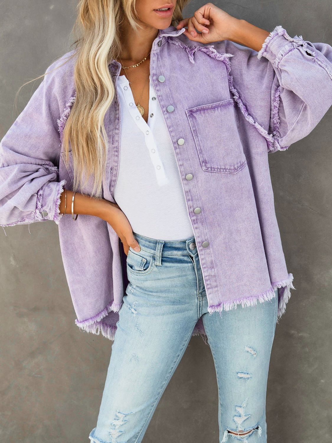 Lavender frayed denim overshirt jacket with button front and chest pockets.