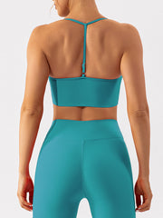 Teal ribbed halterneck active bra with adjustable strap detail.