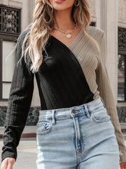 Colorblock long sleeve bodysuit in black and tan with a crossover neckline and textured knit.