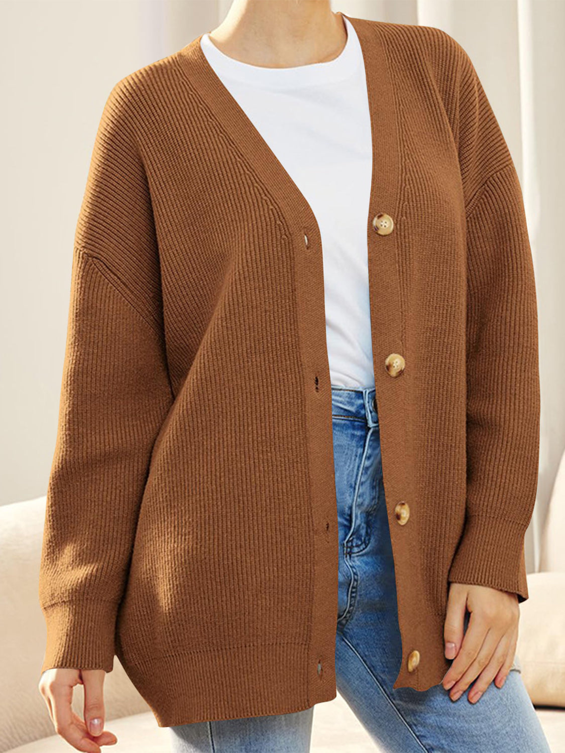 Ochre ribbed knit cardigan with balloon sleeves and button front.