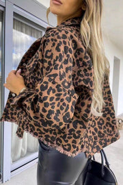 Leopard print denim jacket with frayed hem and buttoned front.
