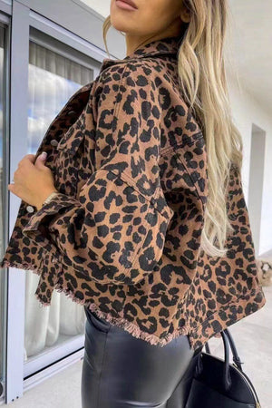 Leopard print denim jacket with frayed hem and buttoned front.