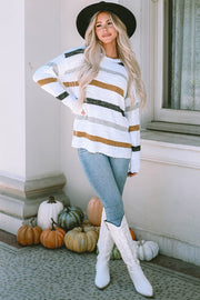 Textured stripe slouchy knit sweater in white with brown, grey, and black stripes.